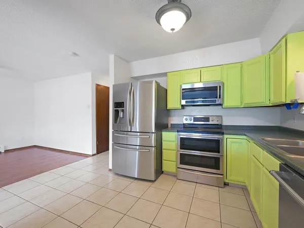 a kitchen with a refrigerator and a sink
