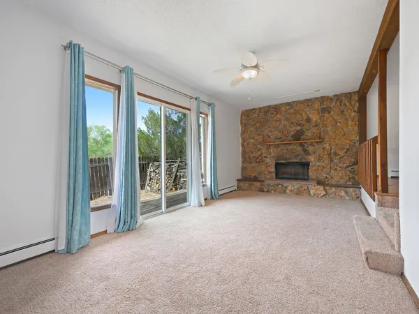an empty room with furniture and a fireplace