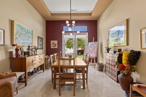 a view of a dining room with furniture wooden floor and a chandelier
