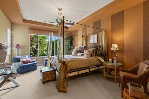 a bedroom with a bed and a lamp on dresser