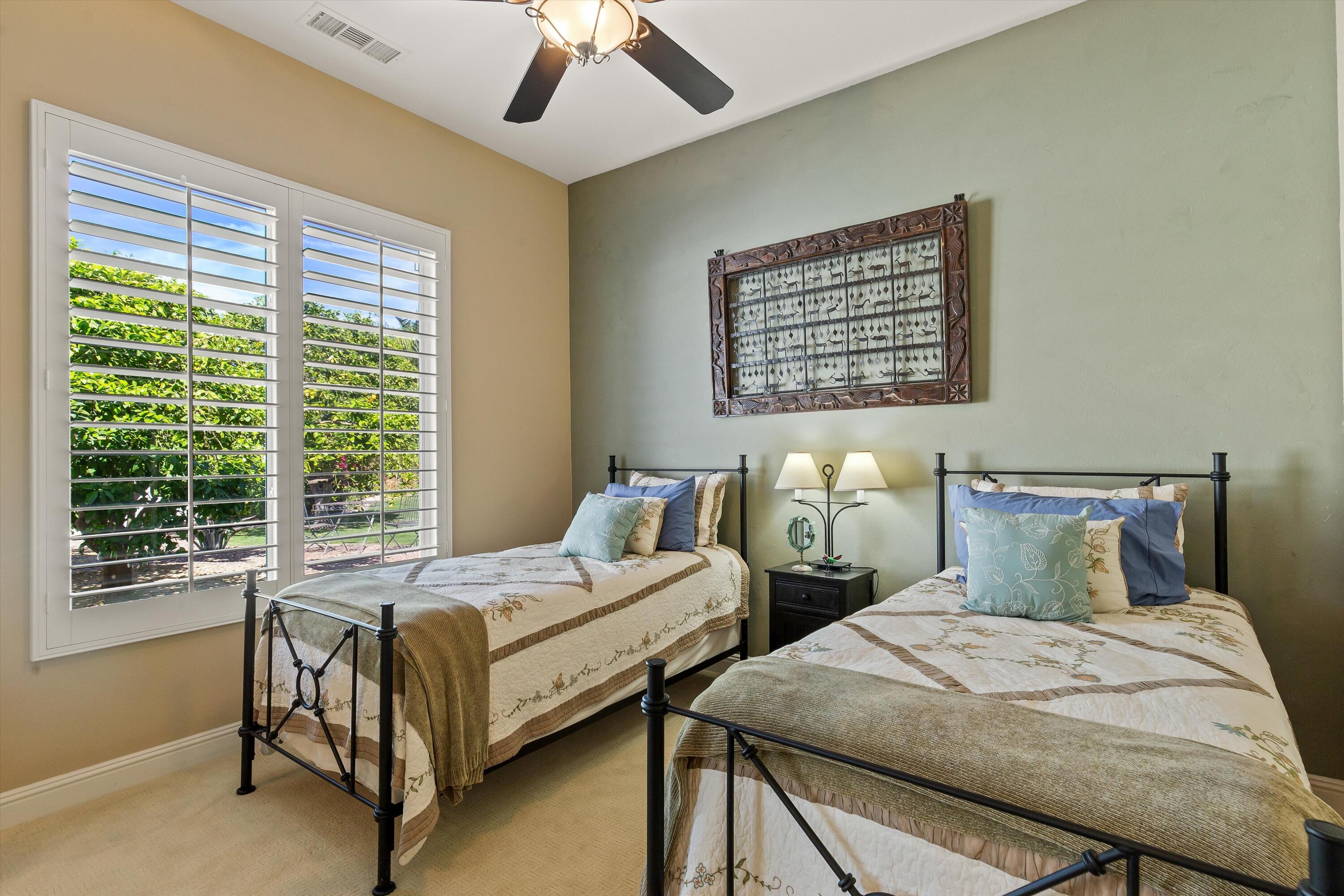 80460 Torreon Way La Quinta, CA 92253 - Photo 26 of 32 a bedroom with two beds and windows