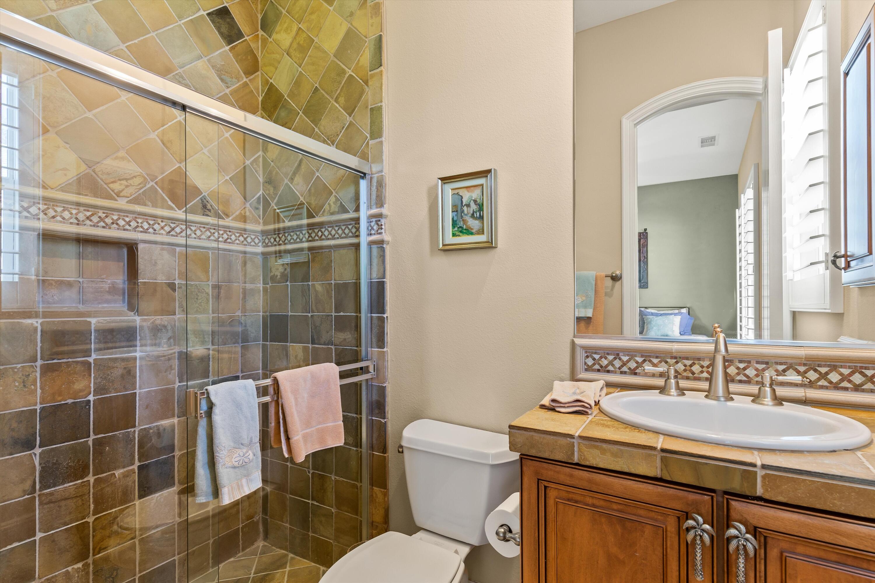80460 Torreon Way La Quinta, CA 92253 - Photo 27 of 32 a bathroom with a sink toilet and shower