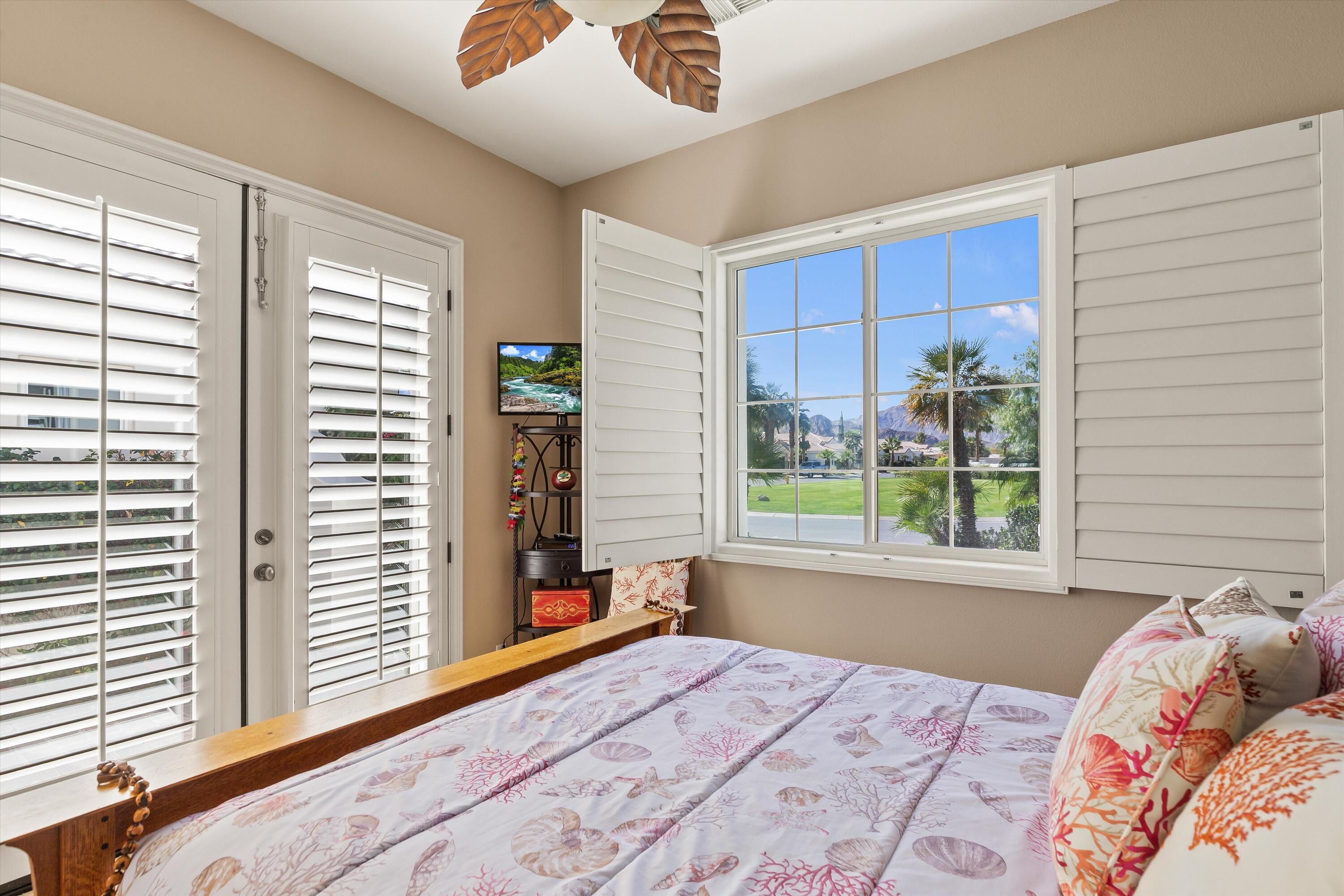 80460 Torreon Way La Quinta, CA 92253 - Photo 29 of 32 a bedroom with a bed and a window