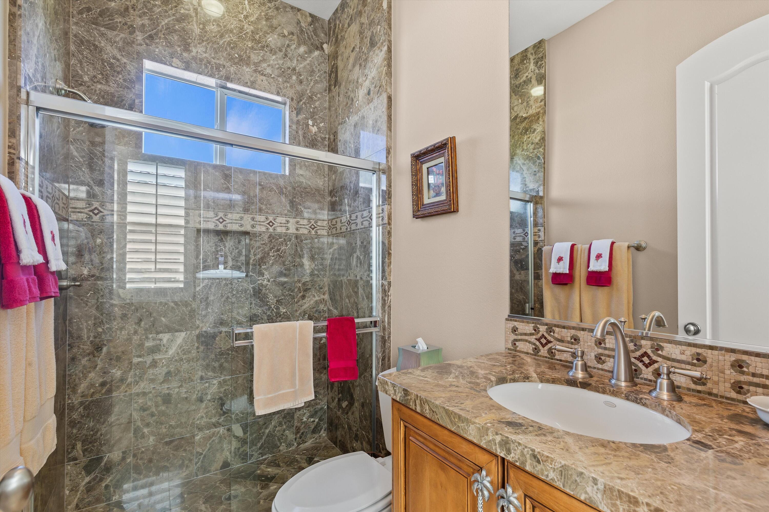 80460 Torreon Way La Quinta, CA 92253 - Photo 30 of 32 a bathroom with a granite countertop sink and a mirror