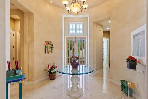 a view of a dining room with a table and chairs