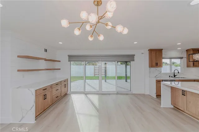a open kitchen with a large window a sink and cabinets