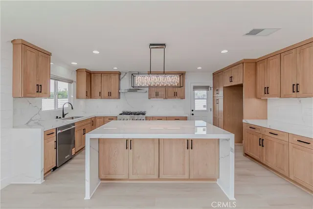 a kitchen with a stove sink and cabinets