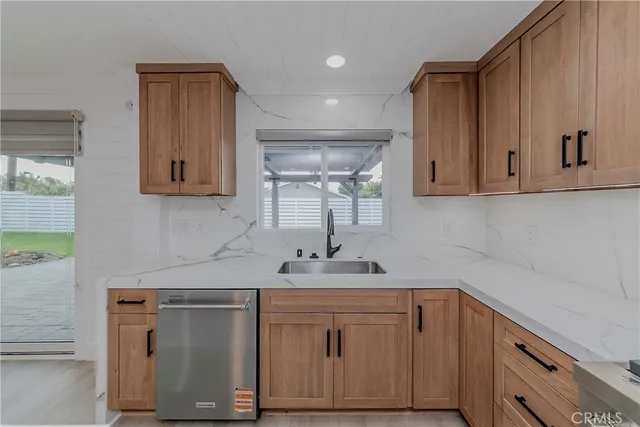 a kitchen with stainless steel appliances white cabinets and a sink