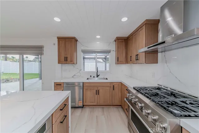 a kitchen with a sink a stove and cabinets