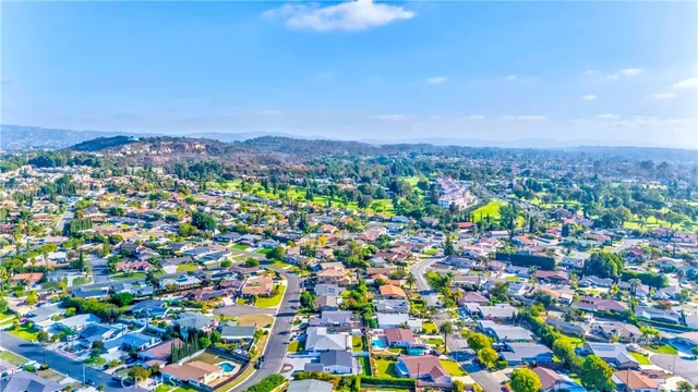 a front view of a house with a yard and balcony