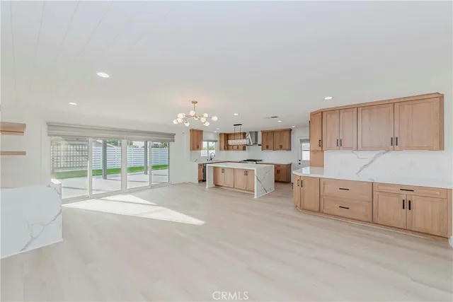 a large white kitchen with cabinets
