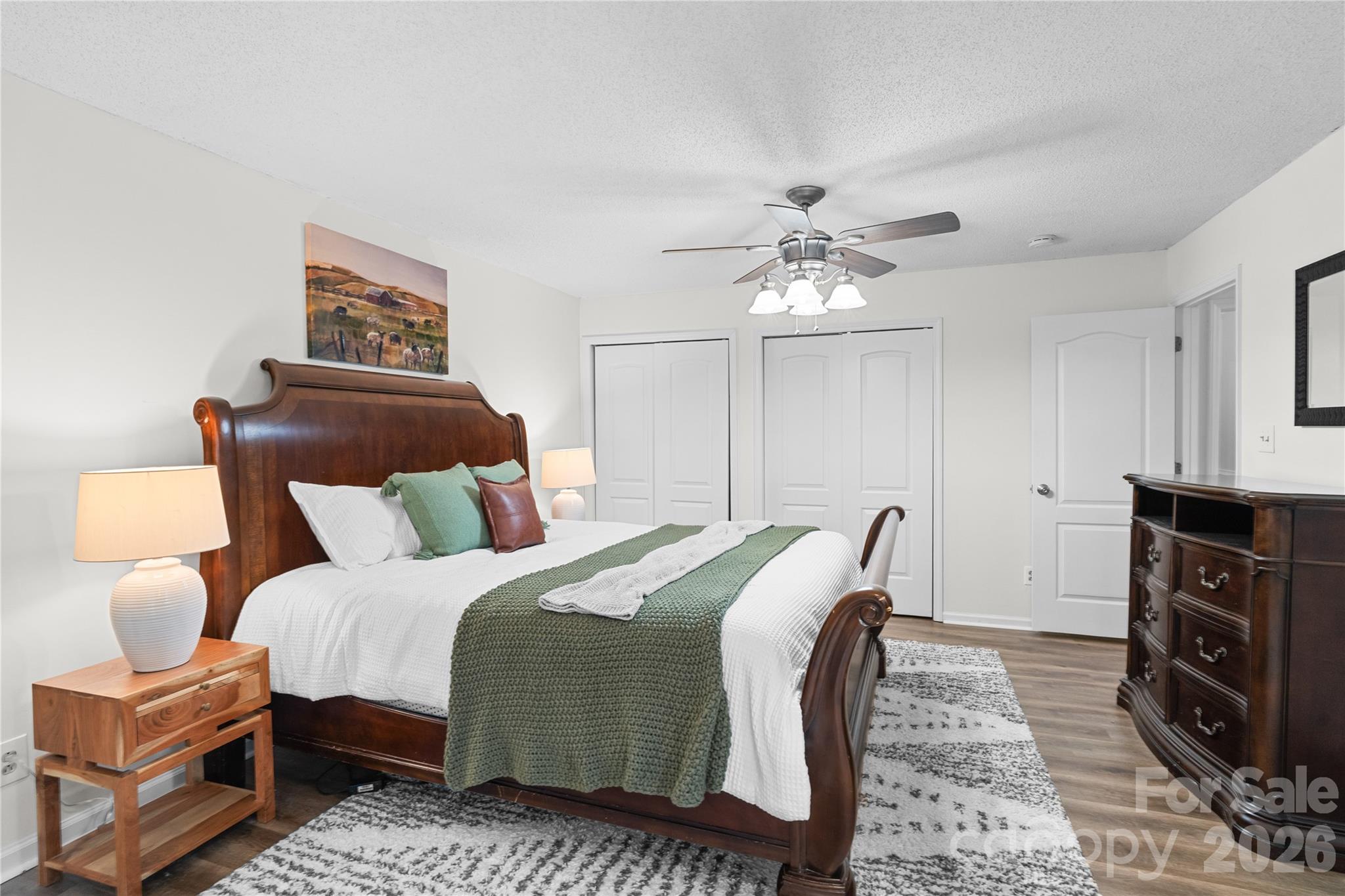 1335 Blacksnake Road Stanley, NC 28164 - Photo 15 of 31 a bedroom with a bed and a chandelier