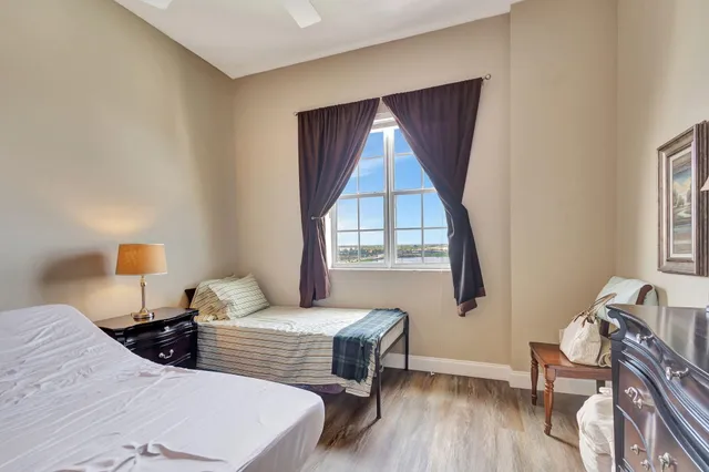 a bedroom with two beds and a window