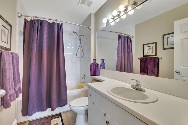 a bathroom with a sink vanity mirror and toilet