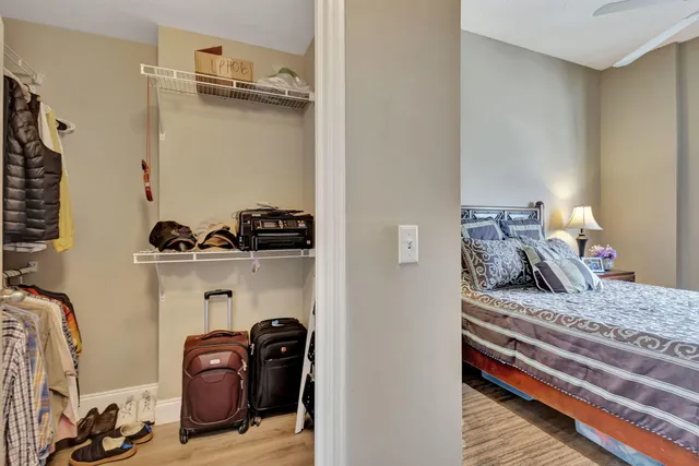 a view of walk in closet with clothes and shoes