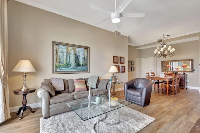 a living room with furniture a dining table and a window