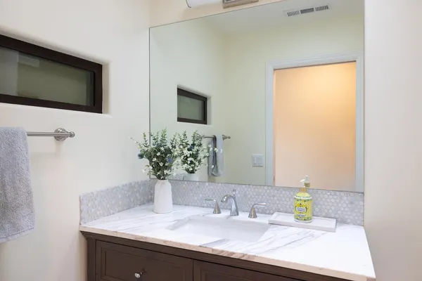 a bathroom with a sink and a mirror