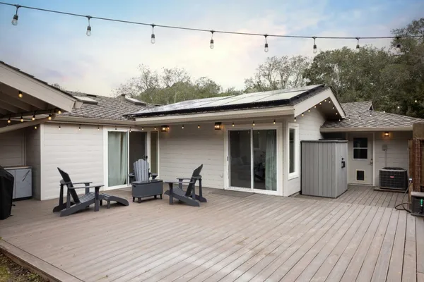 a view of a chair and tables in patio of the house