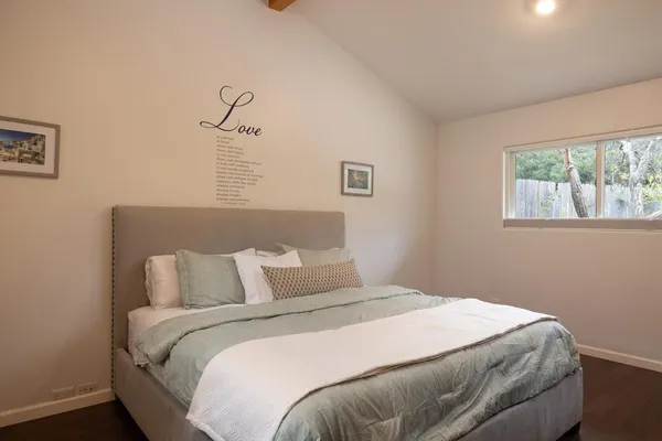 a bedroom with a bed and a window