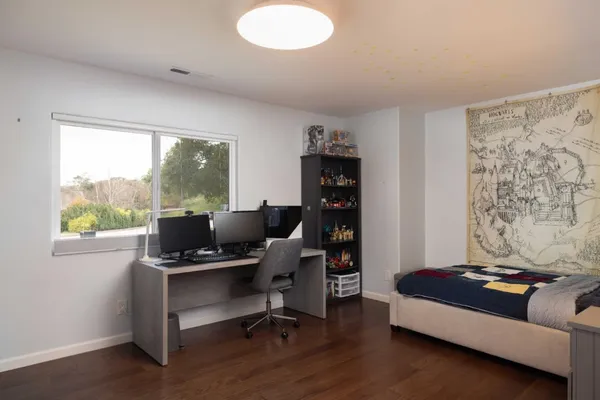 a view of a workspace with furniture and a window