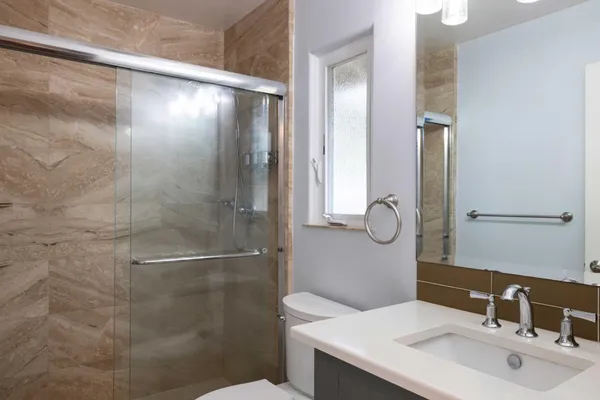 a bathroom with a shower and a sink