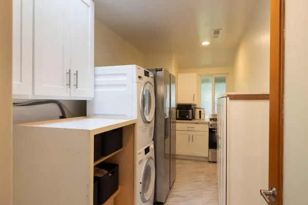 a kitchen with a refrigerator sink stove and cabinets