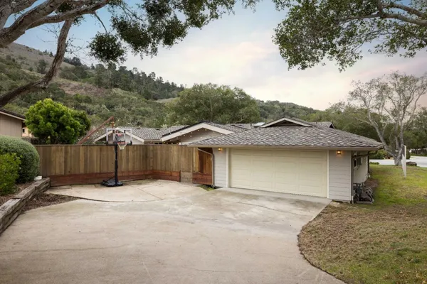 a view of a house with a wooden fence