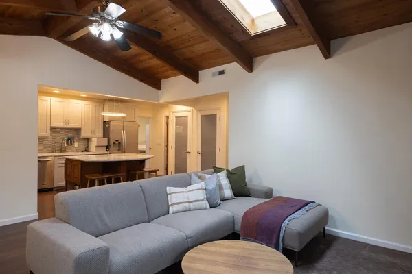 a living room with furniture and a chandelier