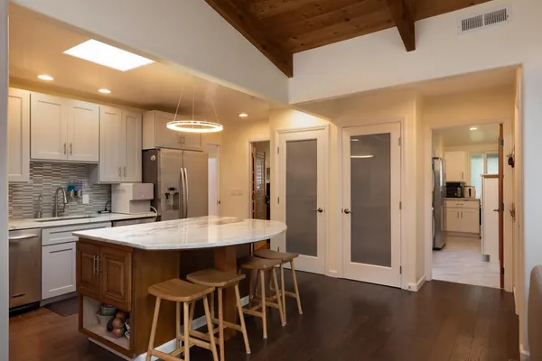 a large kitchen with a table and chairs