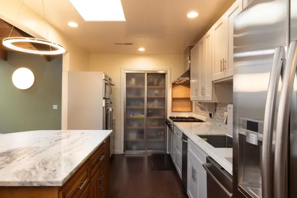 a kitchen with a sink stove and refrigerator
