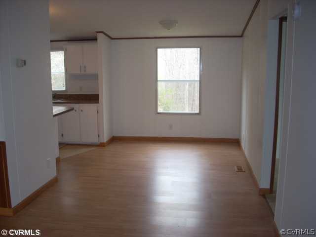 331 State Rte F 189 Louisa, VA 23093 - Photo 4 of 12 an empty room with wooden floor and windows