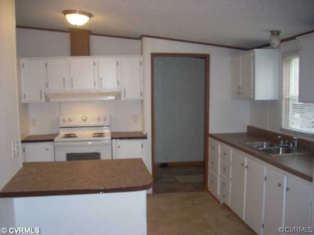 331 State Rte F 189 Louisa, VA 23093 - Photo 6 of 12 a kitchen with granite countertop a sink stove and cabinets