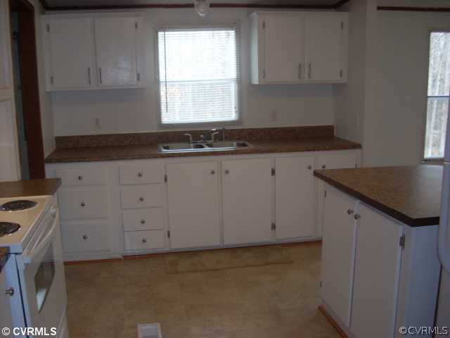 331 State Rte F 189 Louisa, VA 23093 - Photo 7 of 12 a kitchen with granite countertop white cabinets and a sink