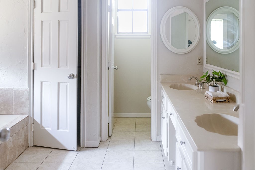18319 Arbor Terrace Drive Spring, TX 77388 - Photo 11 of 34 a bathroom with a granite countertop sink and a mirror