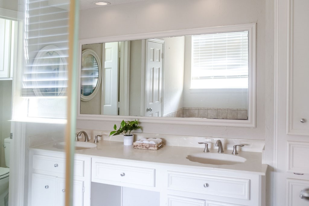 18319 Arbor Terrace Drive Spring, TX 77388 - Photo 13 of 34 a bathroom with a double vanity sink a mirror and next to a window