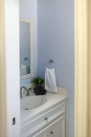 a kitchen with a stove and white cabinets