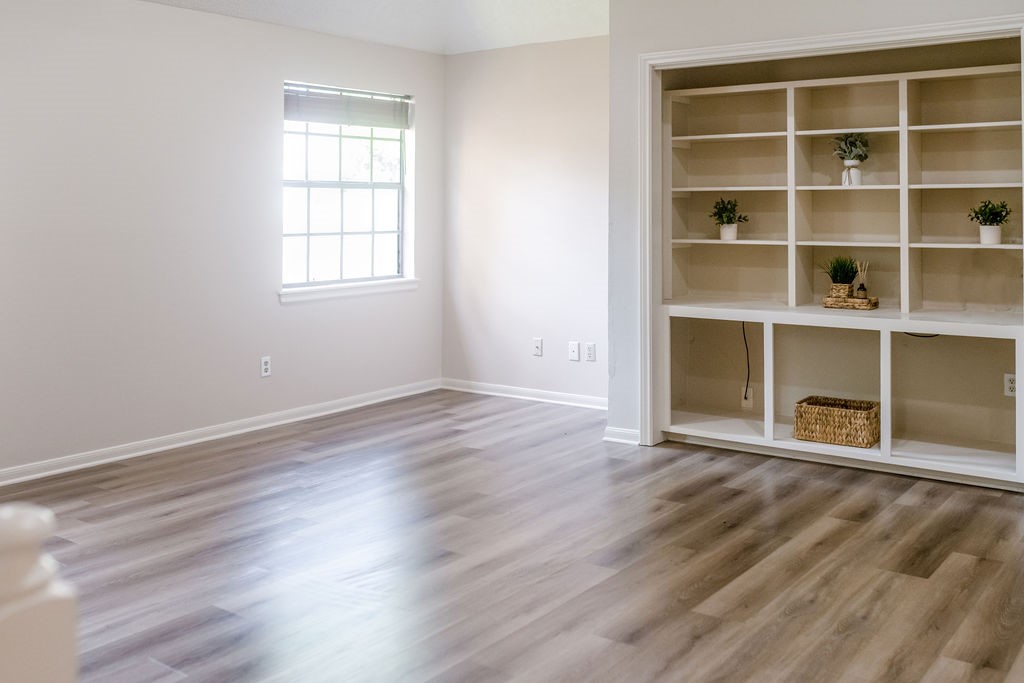 18319 Arbor Terrace Drive Spring, TX 77388 - Photo 22 of 34 a view of an empty room with wooden floor and a window