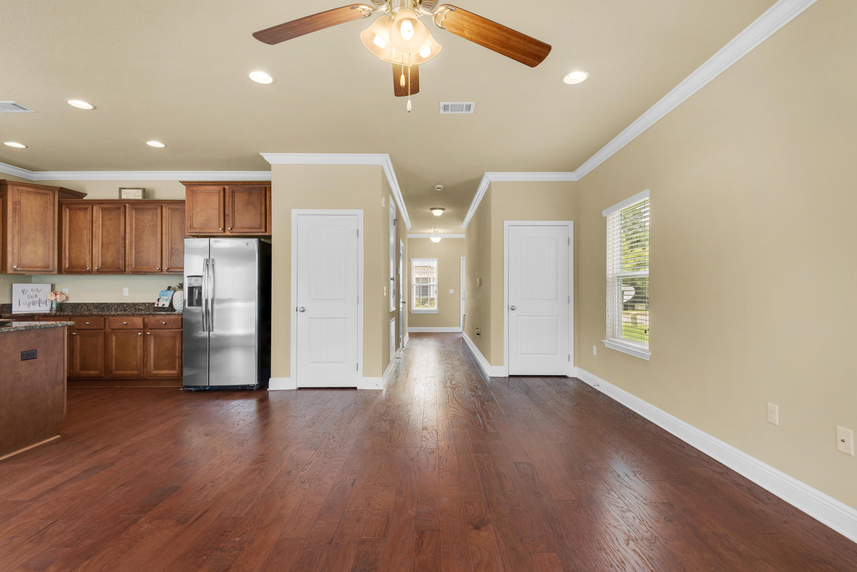 69 Topsail Drive Santa Rosa Beach, FL 32459 - Photo 12 of 34 a view of an empty room and kitchen with wooden floor