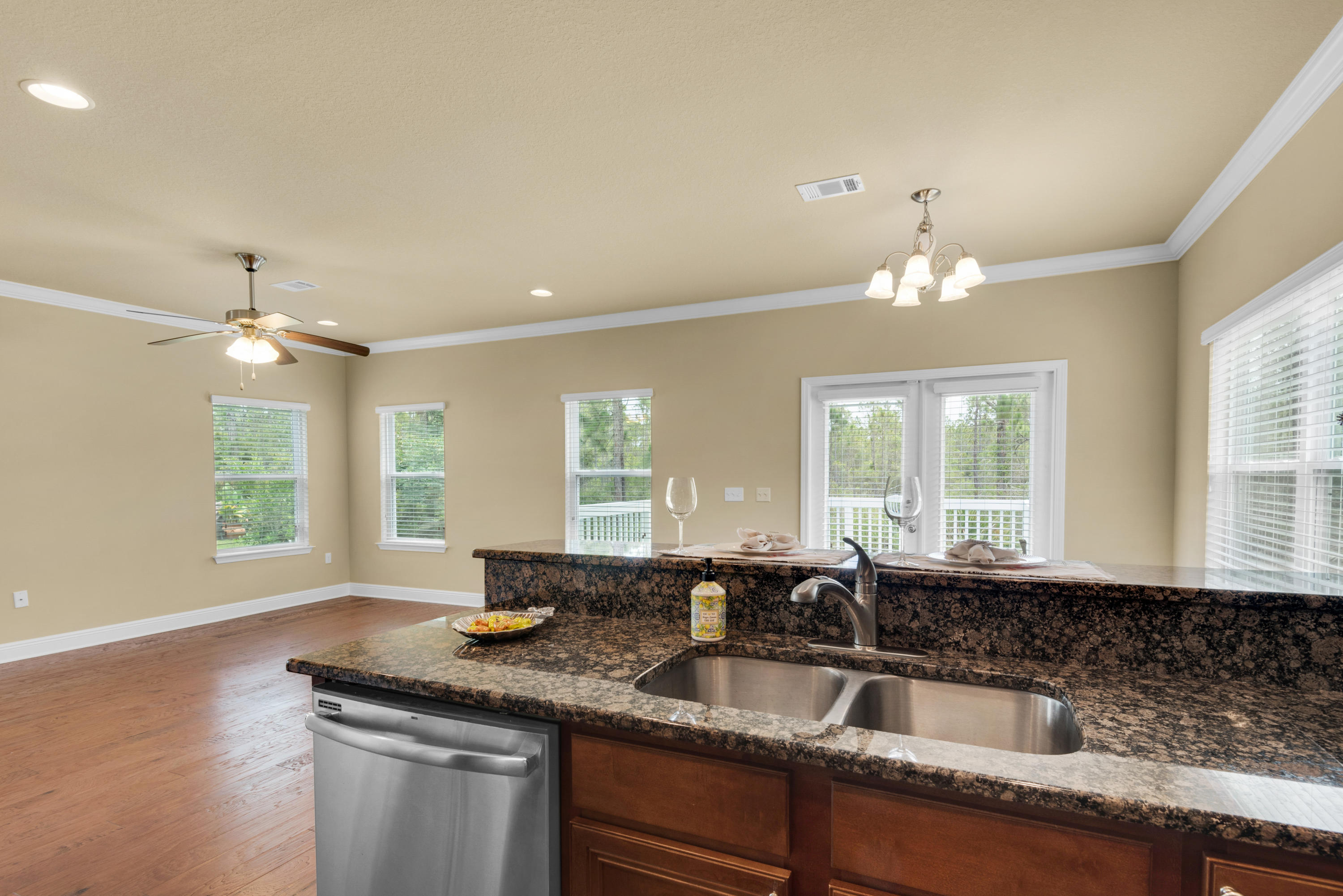 69 Topsail Drive Santa Rosa Beach, FL 32459 - Photo 14 of 34 a kitchen with granite countertop a sink and white cabinets