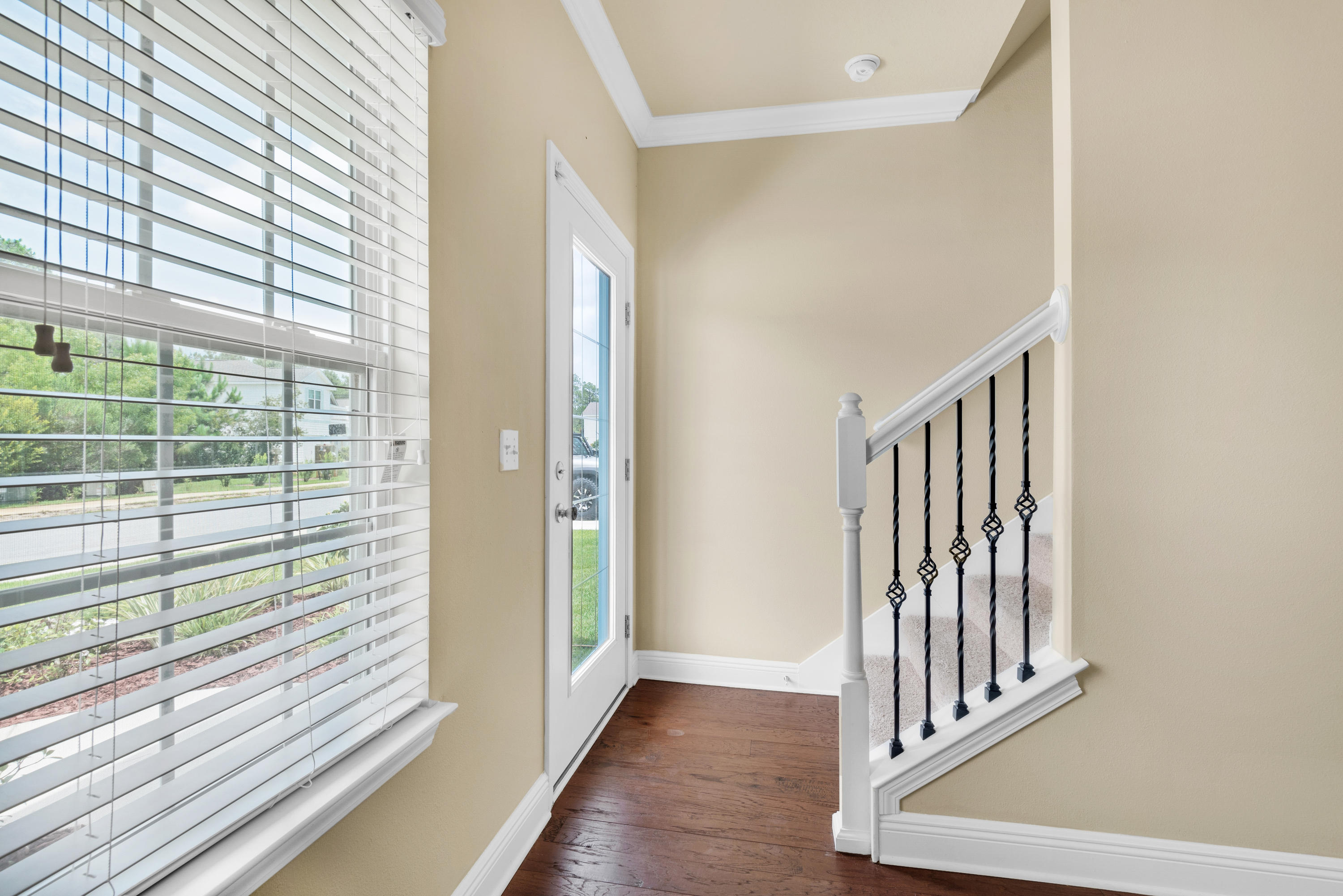 69 Topsail Drive Santa Rosa Beach, FL 32459 - Photo 2 of 34 a view of a hallway with wooden floor and staircase