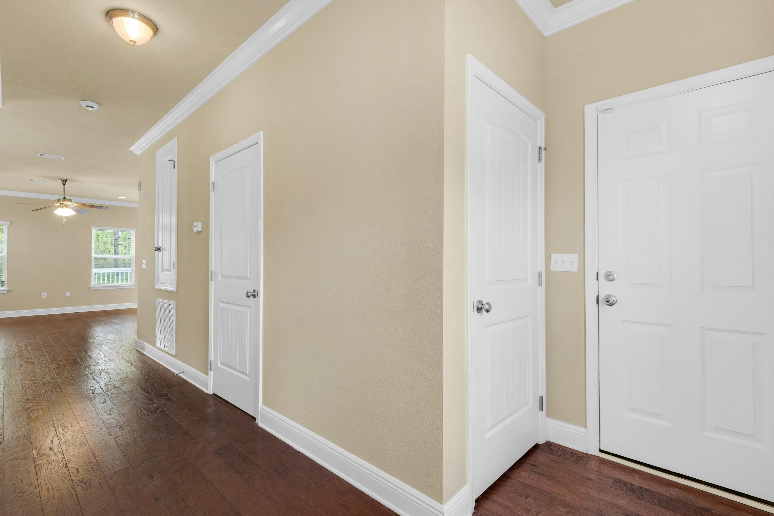 69 Topsail Drive Santa Rosa Beach, FL 32459 - Photo 3 of 34 a view of a hallway with wooden floor