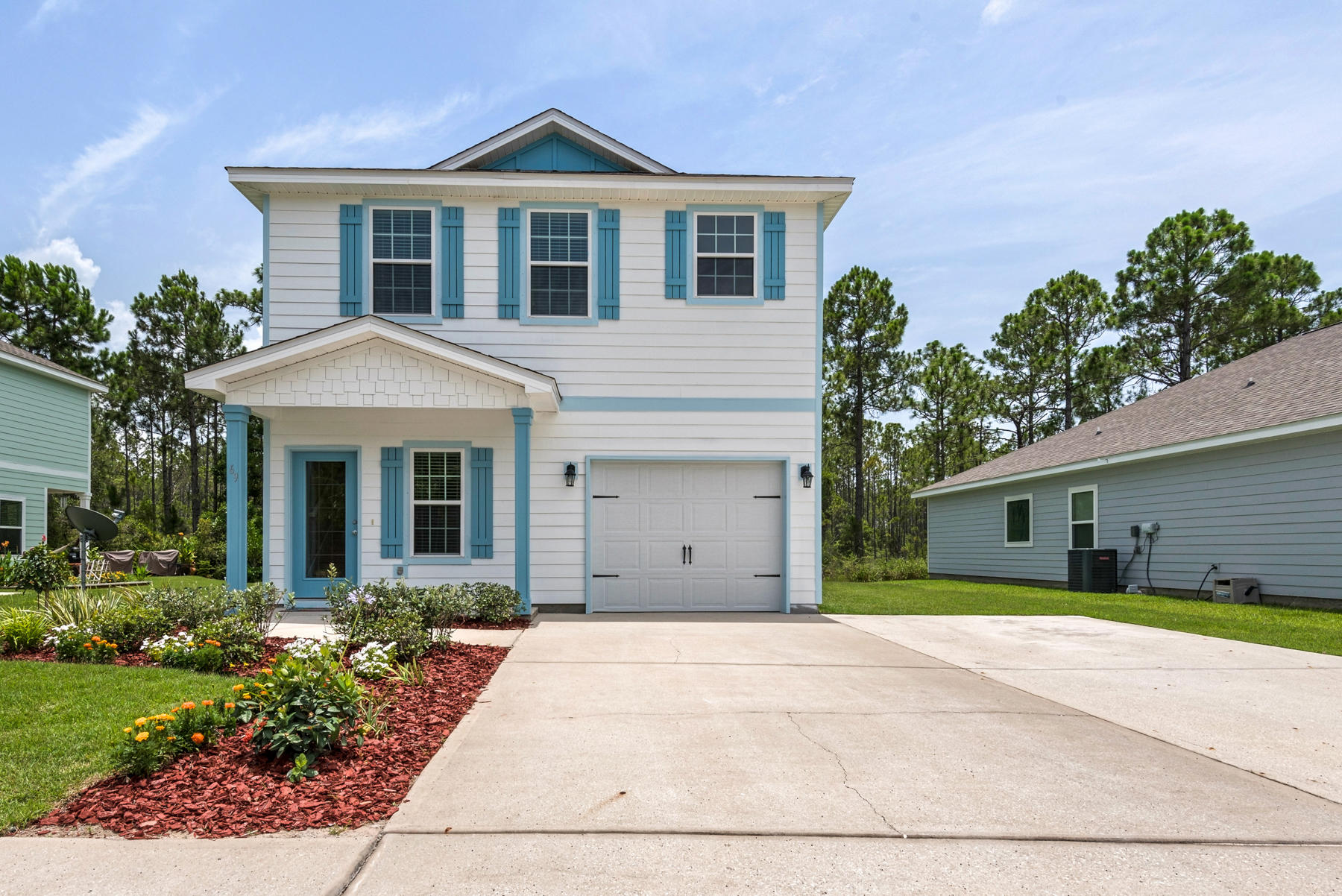 69 Topsail Drive Santa Rosa Beach, FL 32459 - Photo 30 of 34 a front view of a house with garden