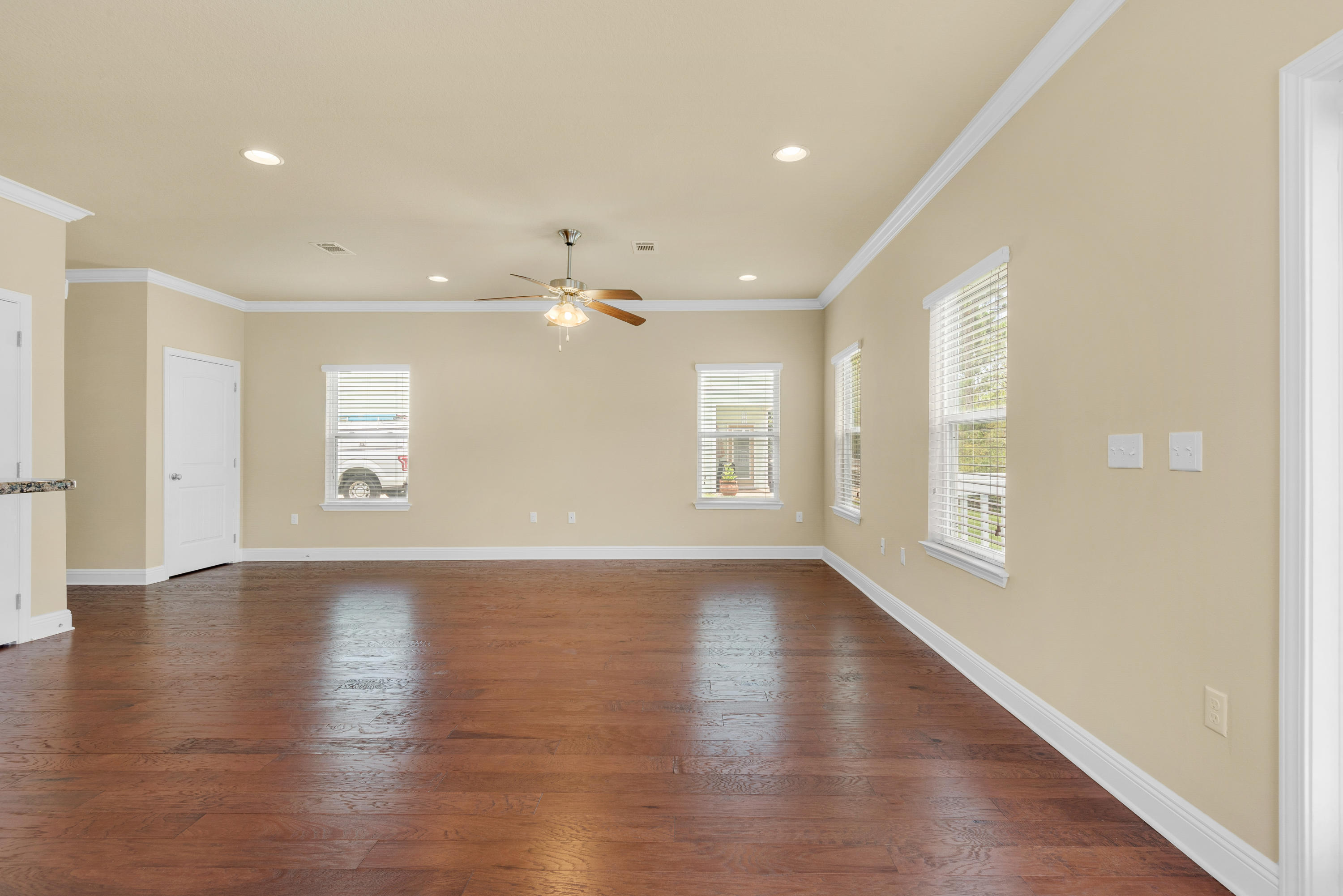 69 Topsail Drive Santa Rosa Beach, FL 32459 - Photo 5 of 34 a view of an empty room with a window and wooden floor