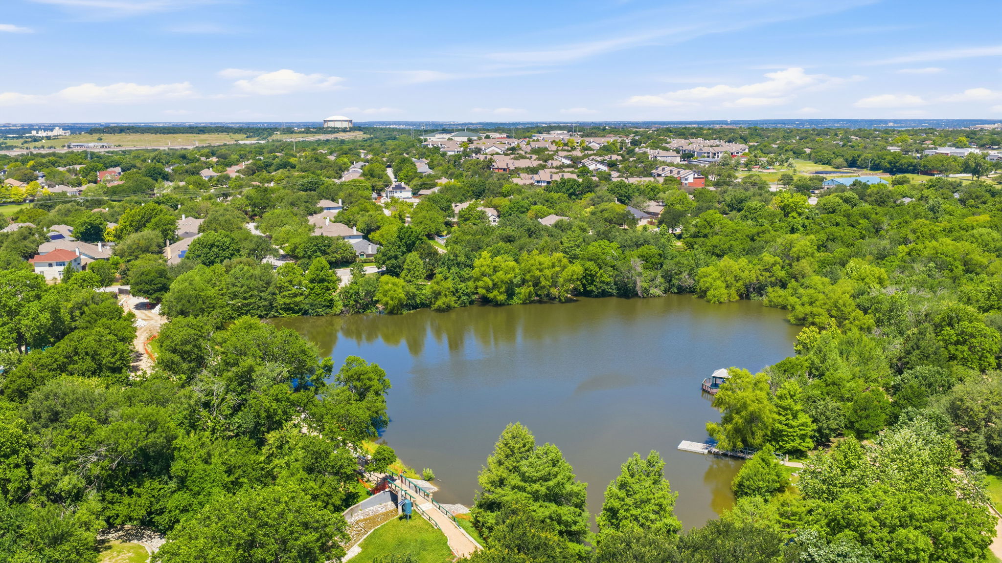 14818 Yellowleaf Trail Austin, TX 78728 - Photo 23 of 26 Expansive aerial perspective showcasing a significant body of water surrounded by dense, mature tree coverage