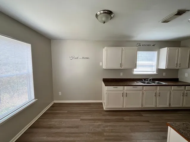 a kitchen with a stove a sink and a microwave