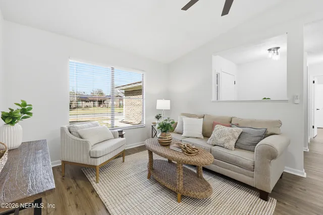 a living room with furniture and a large window