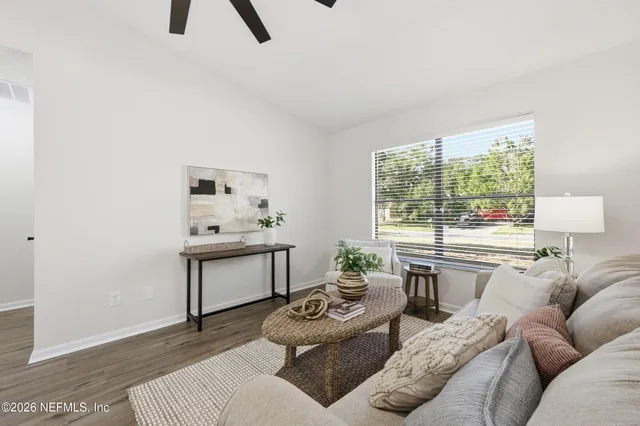 a living room with furniture and a large window