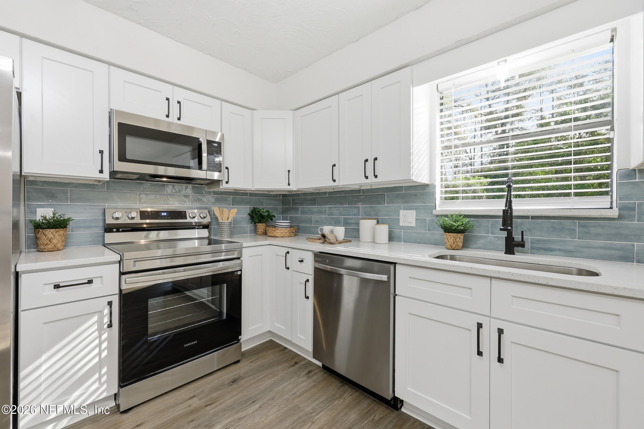 2171 Carter Braxton Road Orange Park, FL 32073 - Photo 3 of 39 a kitchen with cabinets stainless steel appliances a sink and a window
