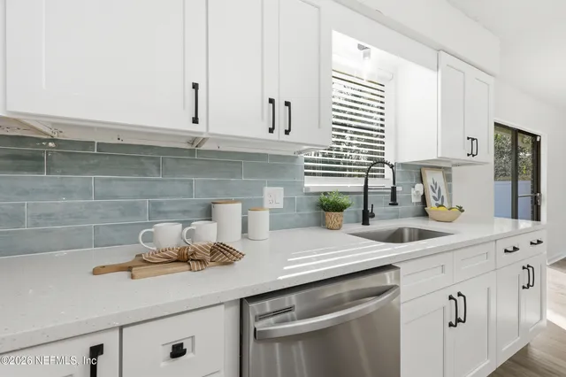a kitchen with appliances cabinets and a counter top space