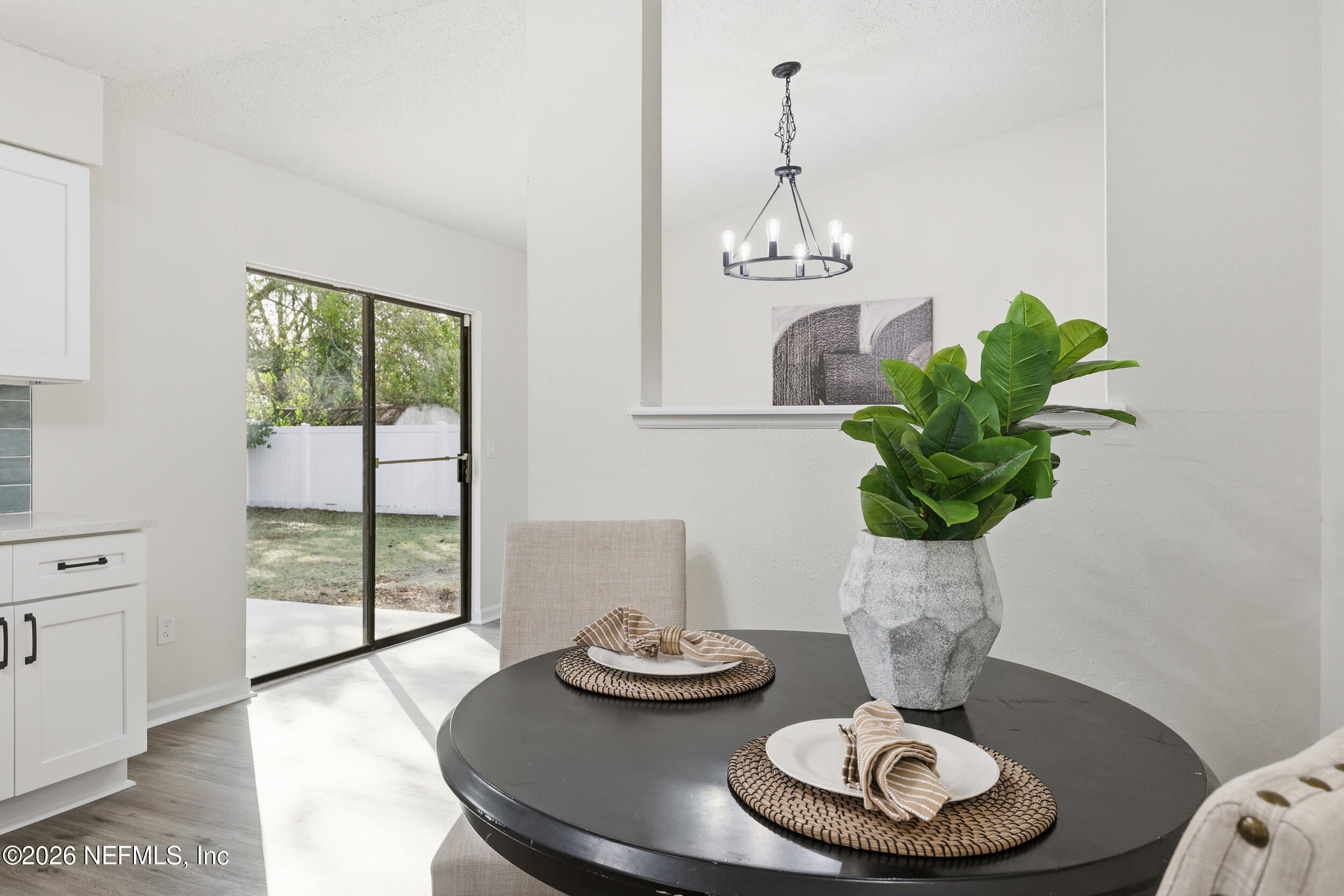 2171 Carter Braxton Road Orange Park, FL 32073 - Photo 34 of 39 a dining room with furniture a potted plant and a chandelier